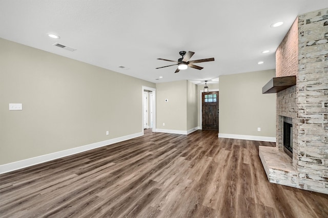 unfurnished living room with a fireplace, hardwood / wood-style flooring, and ceiling fan