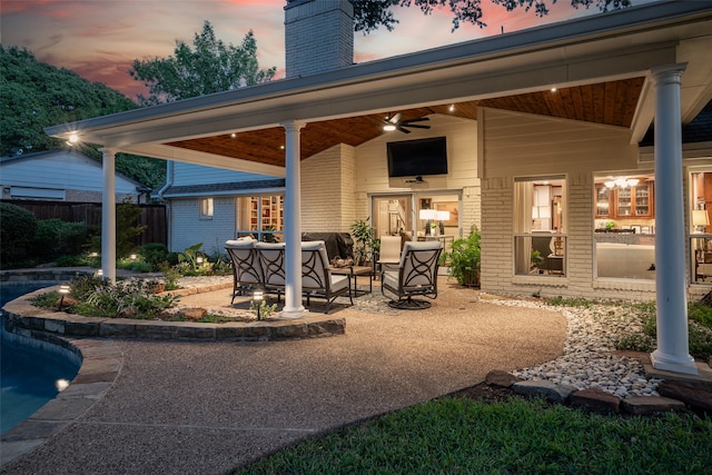 patio terrace at dusk featuring ceiling fan