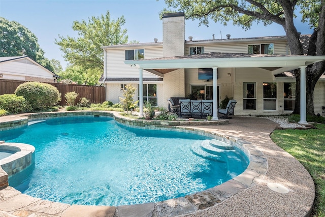 view of pool with ceiling fan and a patio