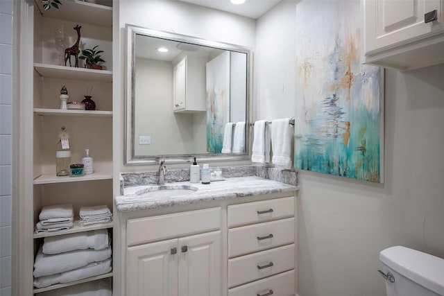 bathroom featuring toilet and vanity