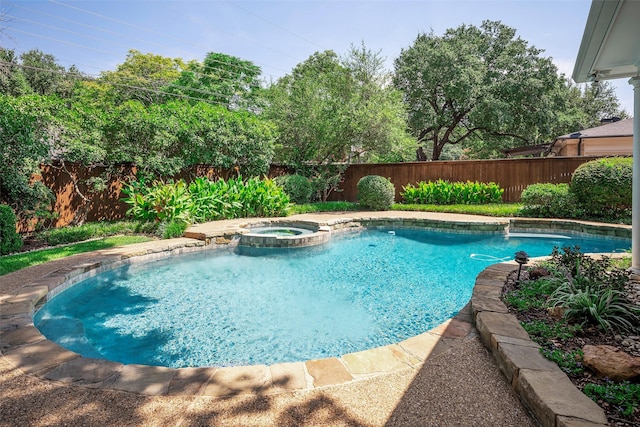 view of pool featuring an in ground hot tub