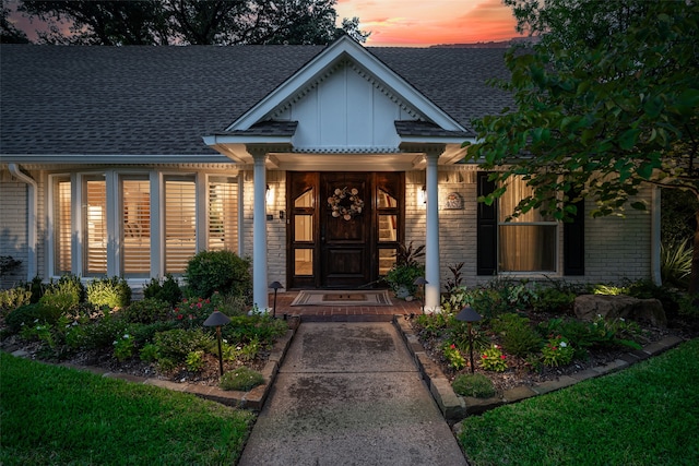 view of exterior entry at dusk