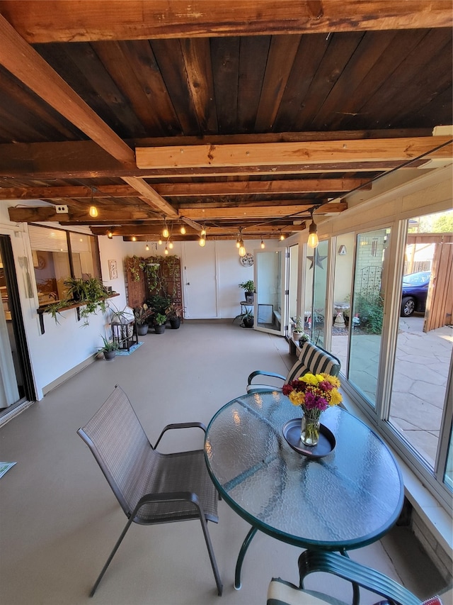 dining area with beam ceiling