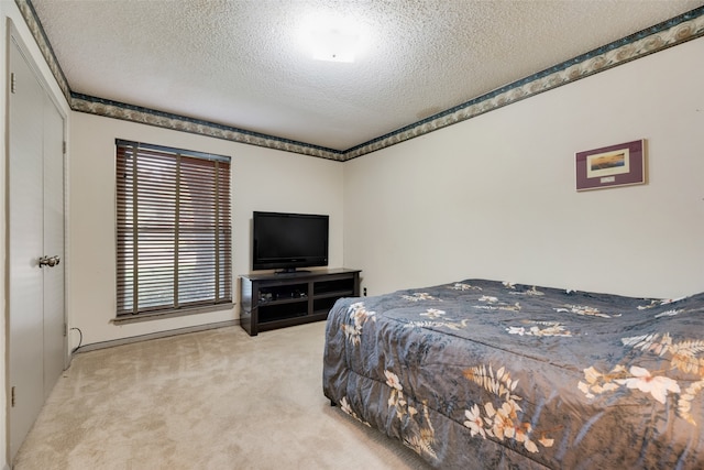 carpeted bedroom with a textured ceiling