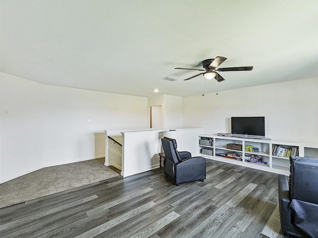 living room with ceiling fan and dark hardwood / wood-style floors