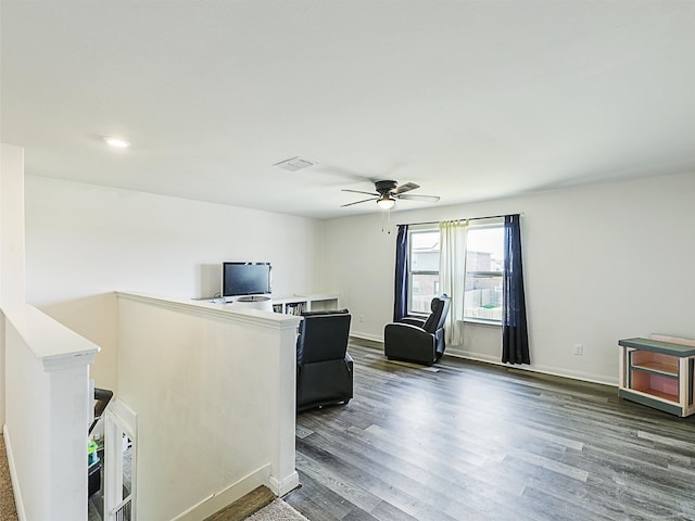 living room with ceiling fan and dark hardwood / wood-style flooring