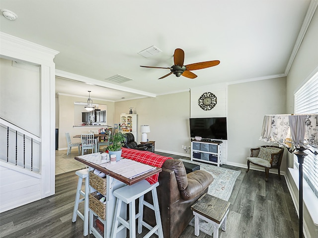 living room featuring ornamental molding, dark wood-type flooring, and ceiling fan