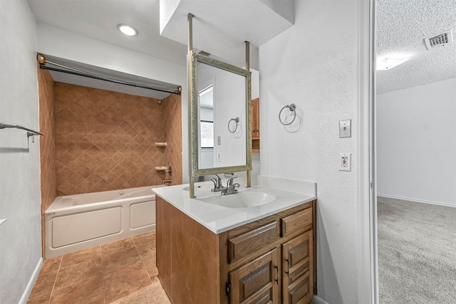 bathroom featuring a textured ceiling, vanity, tub / shower combination, and tile patterned flooring