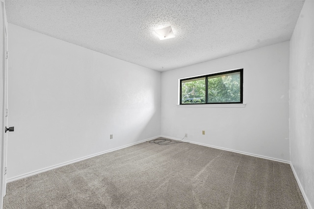 carpeted empty room with a textured ceiling