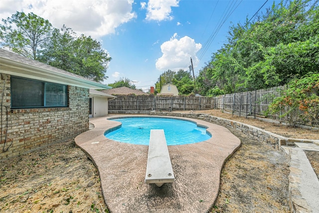 view of pool featuring a diving board and a patio