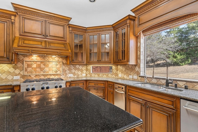 kitchen with a sink, stainless steel dishwasher, range, tasteful backsplash, and brown cabinetry