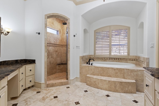 bathroom featuring a healthy amount of sunlight, vanity, a bath, and tiled shower