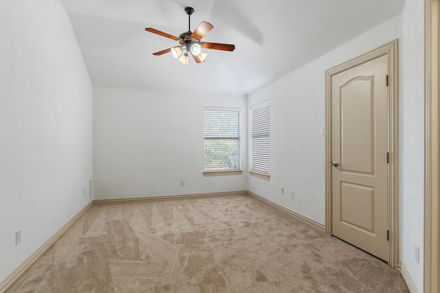 empty room with ceiling fan, carpet flooring, and baseboards