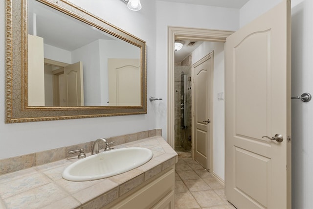 full bath with a shower stall, vanity, visible vents, and tile patterned floors