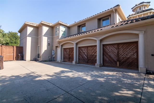 mediterranean / spanish-style house with a garage