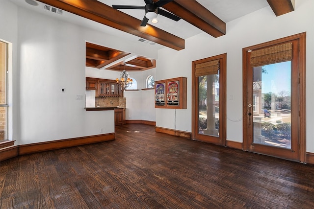 unfurnished living room featuring baseboards, visible vents, dark wood-style flooring, and beamed ceiling