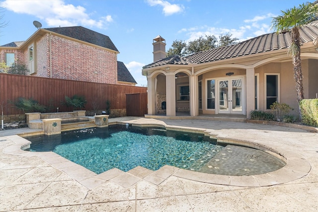 view of swimming pool with a fenced in pool, french doors, a patio area, and fence