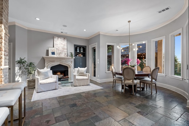 dining area featuring an inviting chandelier and crown molding