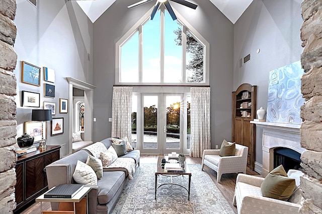 living room featuring high vaulted ceiling, ceiling fan, and plenty of natural light