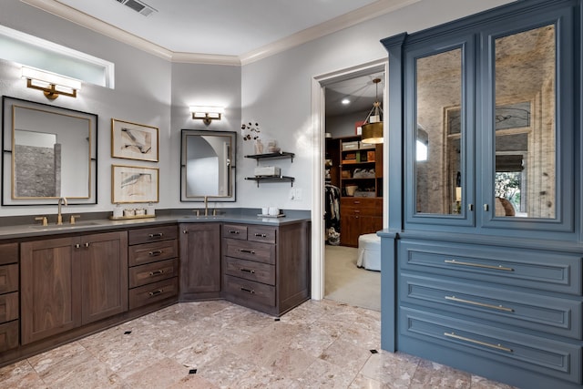 bathroom with ornamental molding and vanity