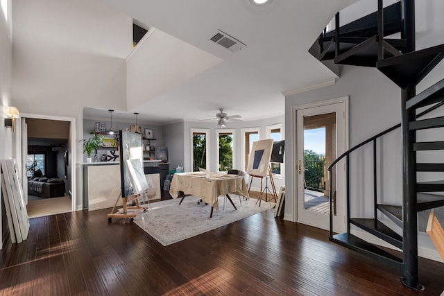 interior space with ornamental molding, a high ceiling, ceiling fan, and dark hardwood / wood-style flooring