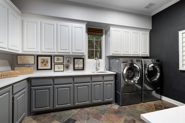 laundry room featuring crown molding, sink, independent washer and dryer, and cabinets