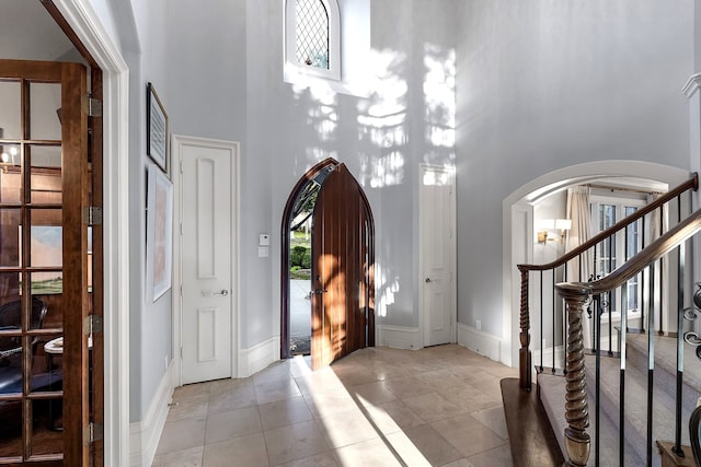 tiled foyer entrance with a high ceiling