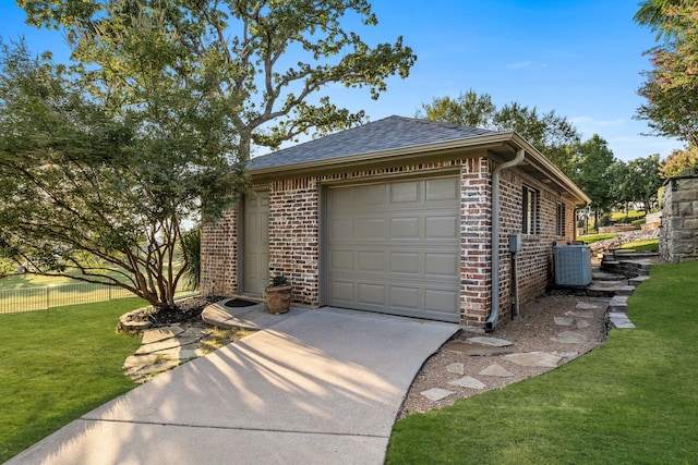 garage with a yard and central AC