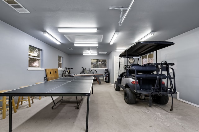 recreation room featuring a textured ceiling