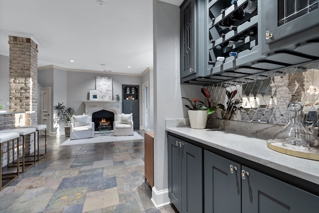 bar with gray cabinets, ornamental molding, and tasteful backsplash