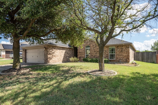 single story home featuring a front yard and a garage