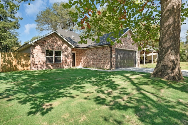 view of front facade featuring a front yard and a garage