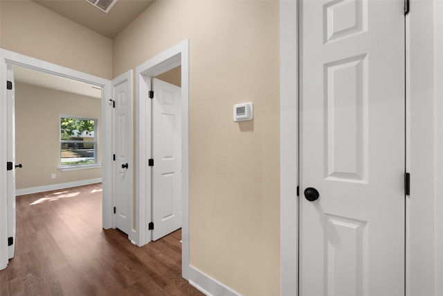 hallway featuring dark hardwood / wood-style flooring