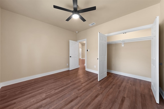 unfurnished bedroom with a closet, ceiling fan, and dark hardwood / wood-style floors