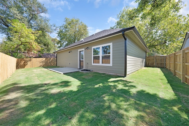 back of house featuring a lawn and a patio