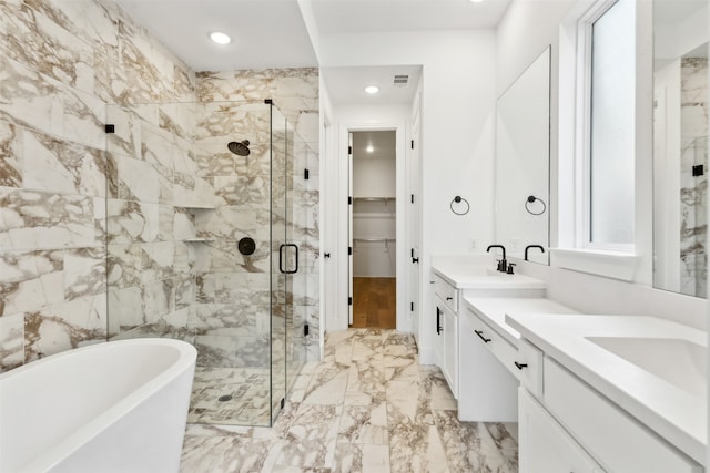 bathroom with vanity and separate shower and tub