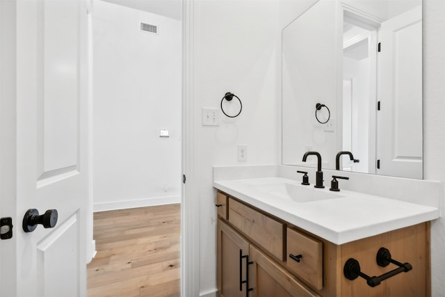 bathroom with hardwood / wood-style floors and vanity