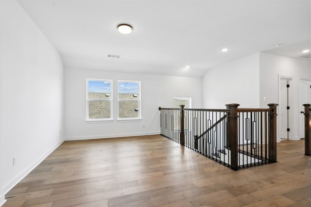 interior space with light hardwood / wood-style floors and vaulted ceiling