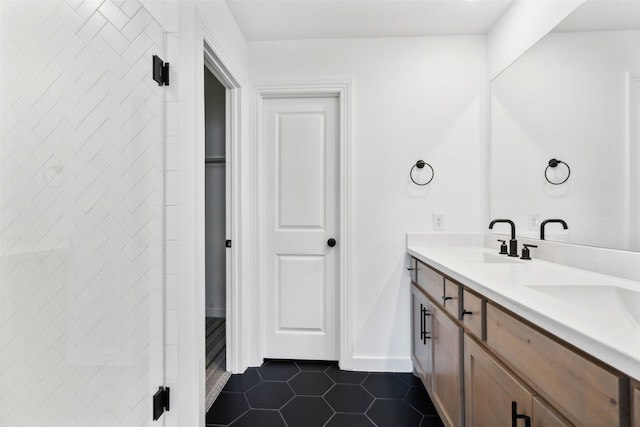 bathroom featuring tile patterned floors, vanity, and tiled shower