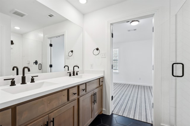 bathroom with tile patterned flooring, vanity, and walk in shower