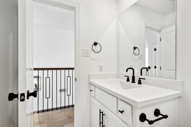 bathroom with vanity and hardwood / wood-style flooring