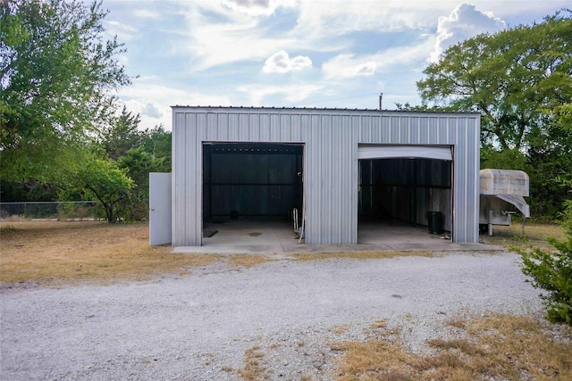 detached garage featuring fence