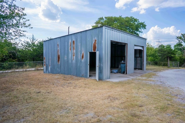 view of pole building with fence