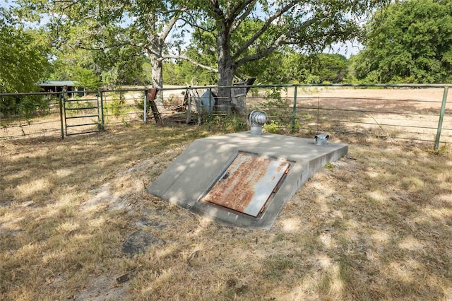 view of storm shelter featuring fence