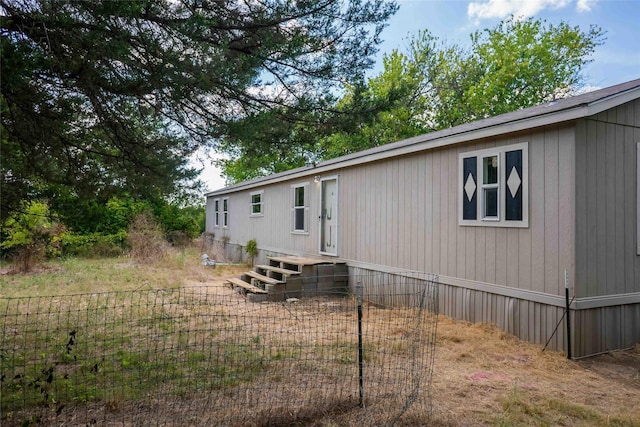 rear view of property with fence