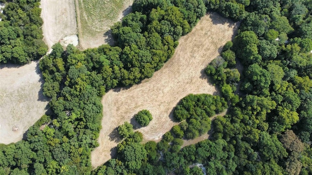 birds eye view of property featuring a view of trees
