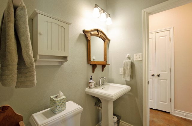 bathroom featuring sink and toilet