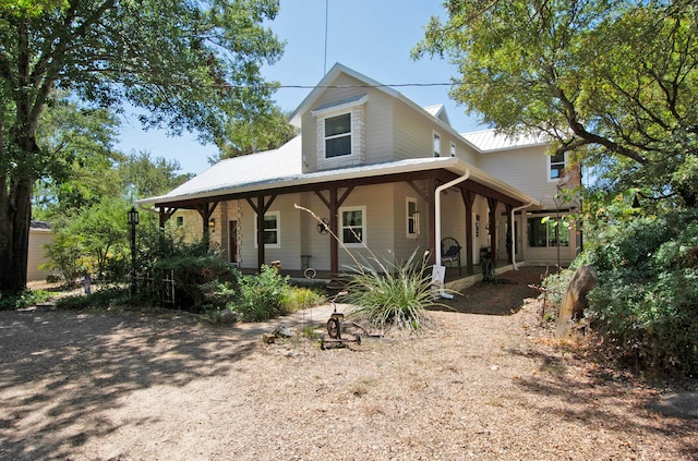 farmhouse-style home featuring covered porch