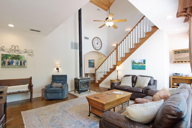 11220 Fm 429, Quinlan, TX 75474 - living room with high vaulted ceiling, a wood stove, stairway, ceiling fan, and baseboards