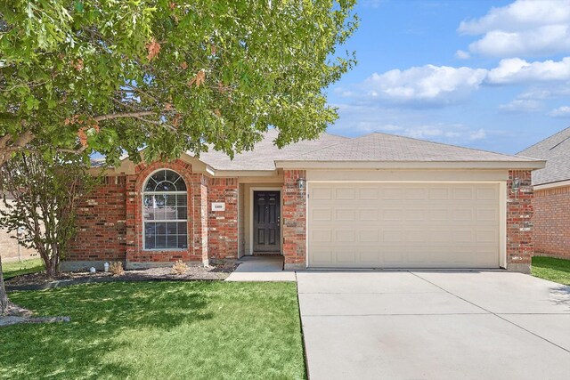 ranch-style house featuring a garage and a front yard